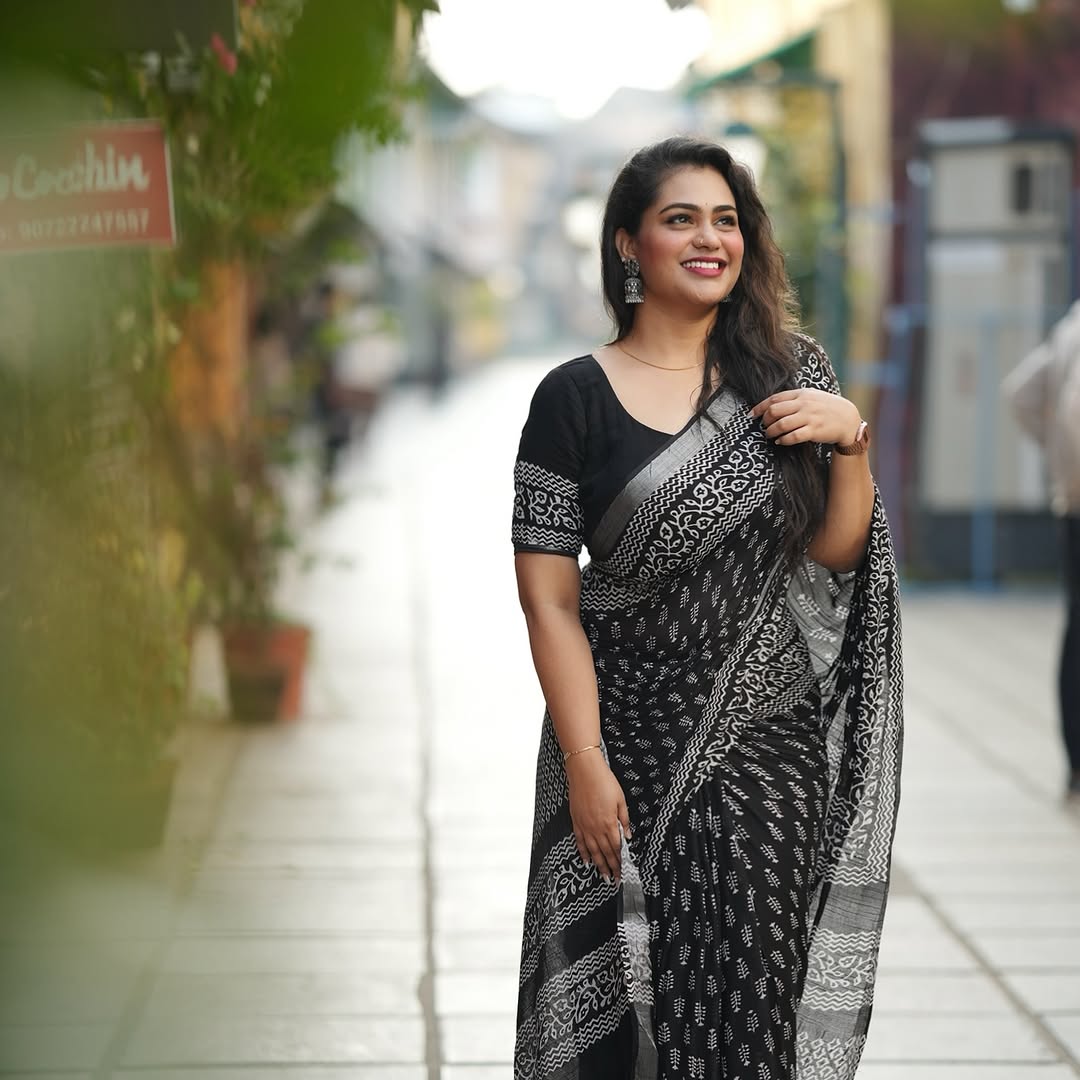 "Full view of the elegant black linen digital print saree with blouse piece, showcasing its modern design and graceful drape."