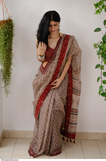Model wearing a beige linen digital printed saree with floral motifs and matching blouse piece

